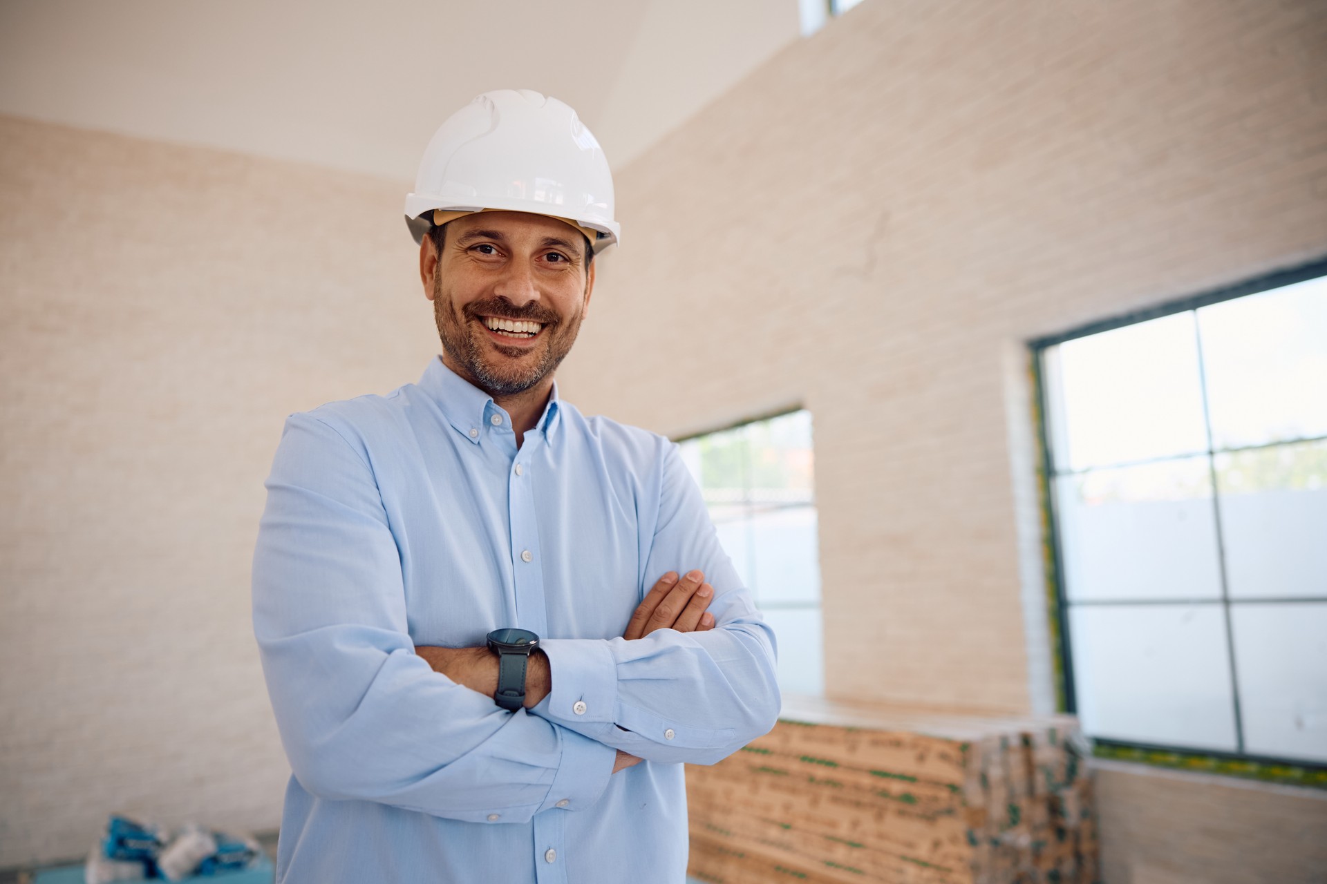 Portrait of confident architect at construction site looking at camera.